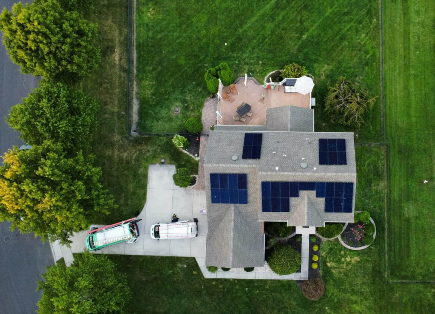 Aerial view of a spacious home with several solar panels installed on the roof, harnessing solar energy.