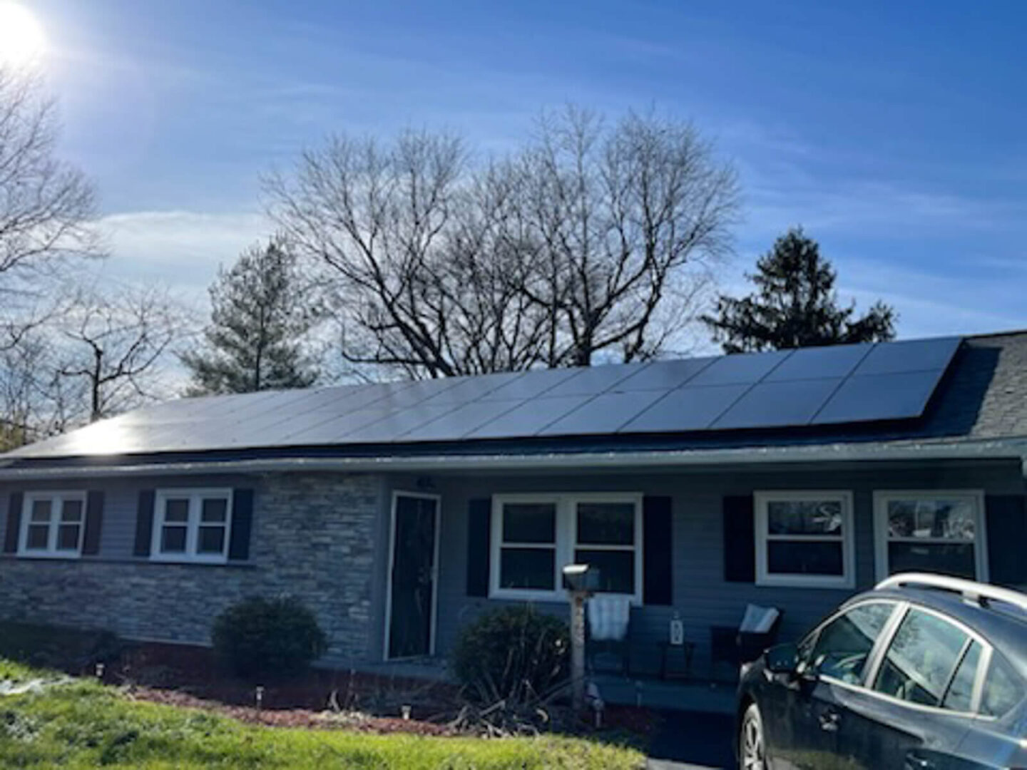 A home with solar panels on the roof, tapping into the sun’s energy to provide eco-friendly electricity.
