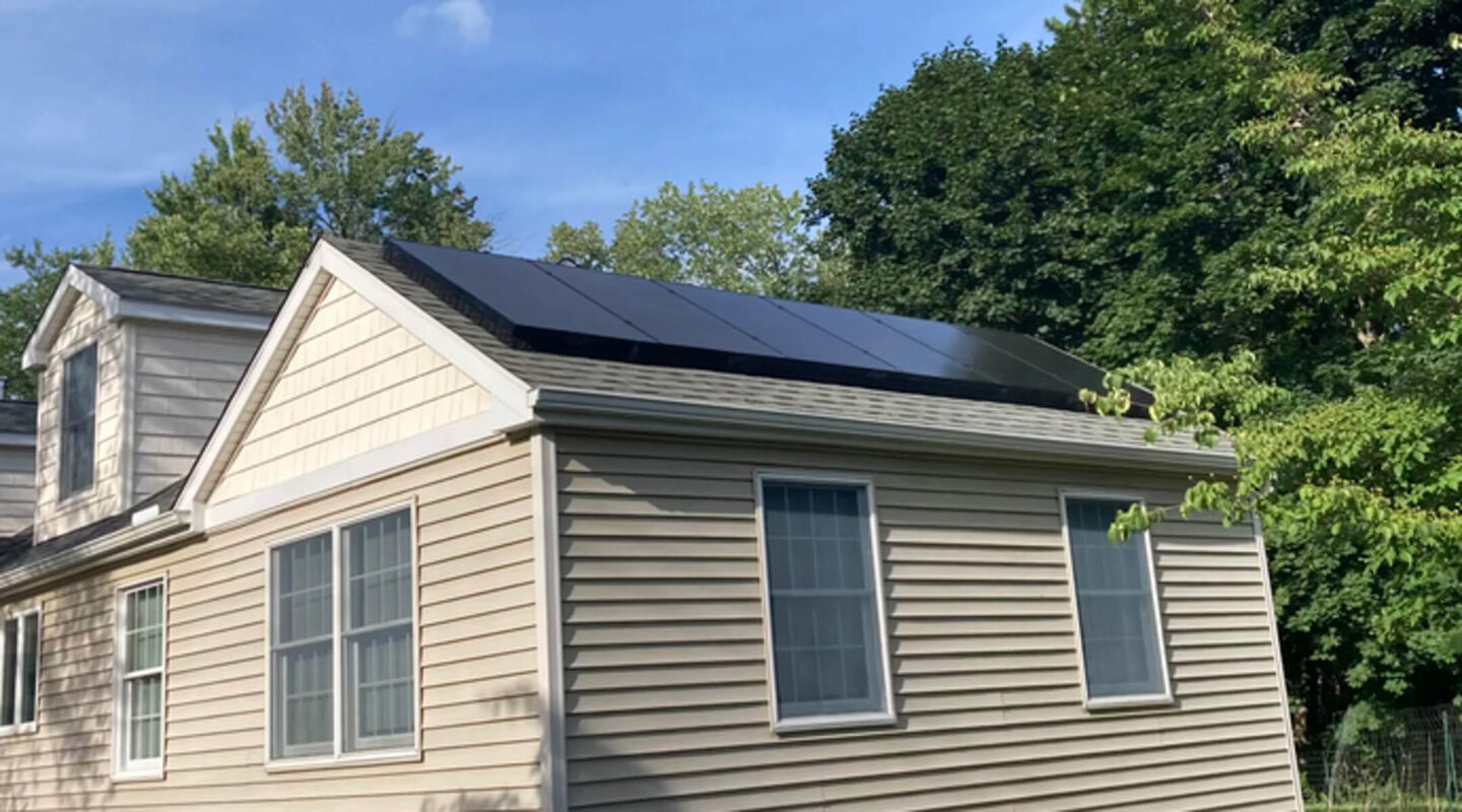 A residential property featuring solar panels on the roof, making use of renewable energy to reduce energy costs.