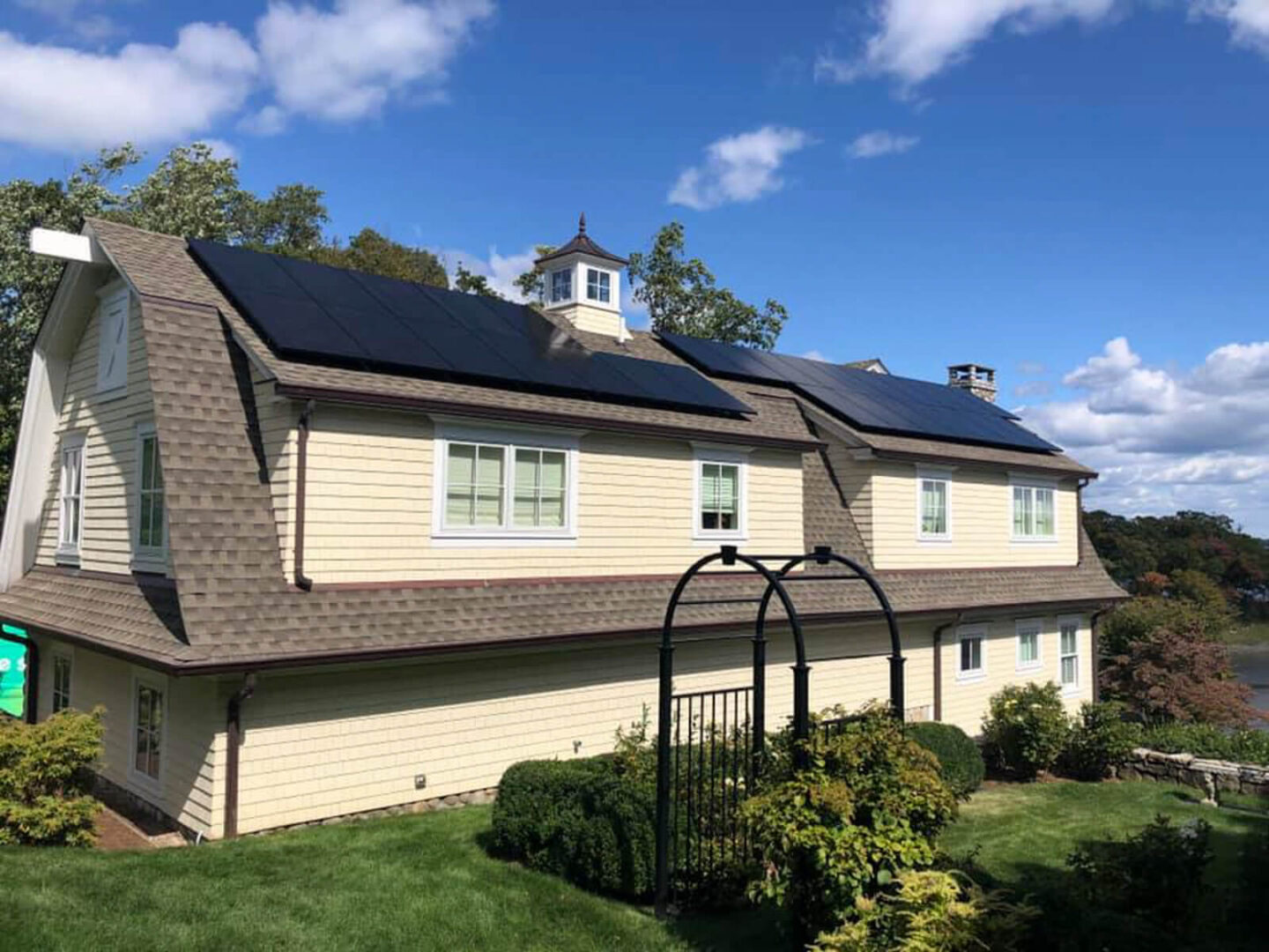 A home with solar panels on the roof, tapping into the sun’s energy to provide eco-friendly electricity.