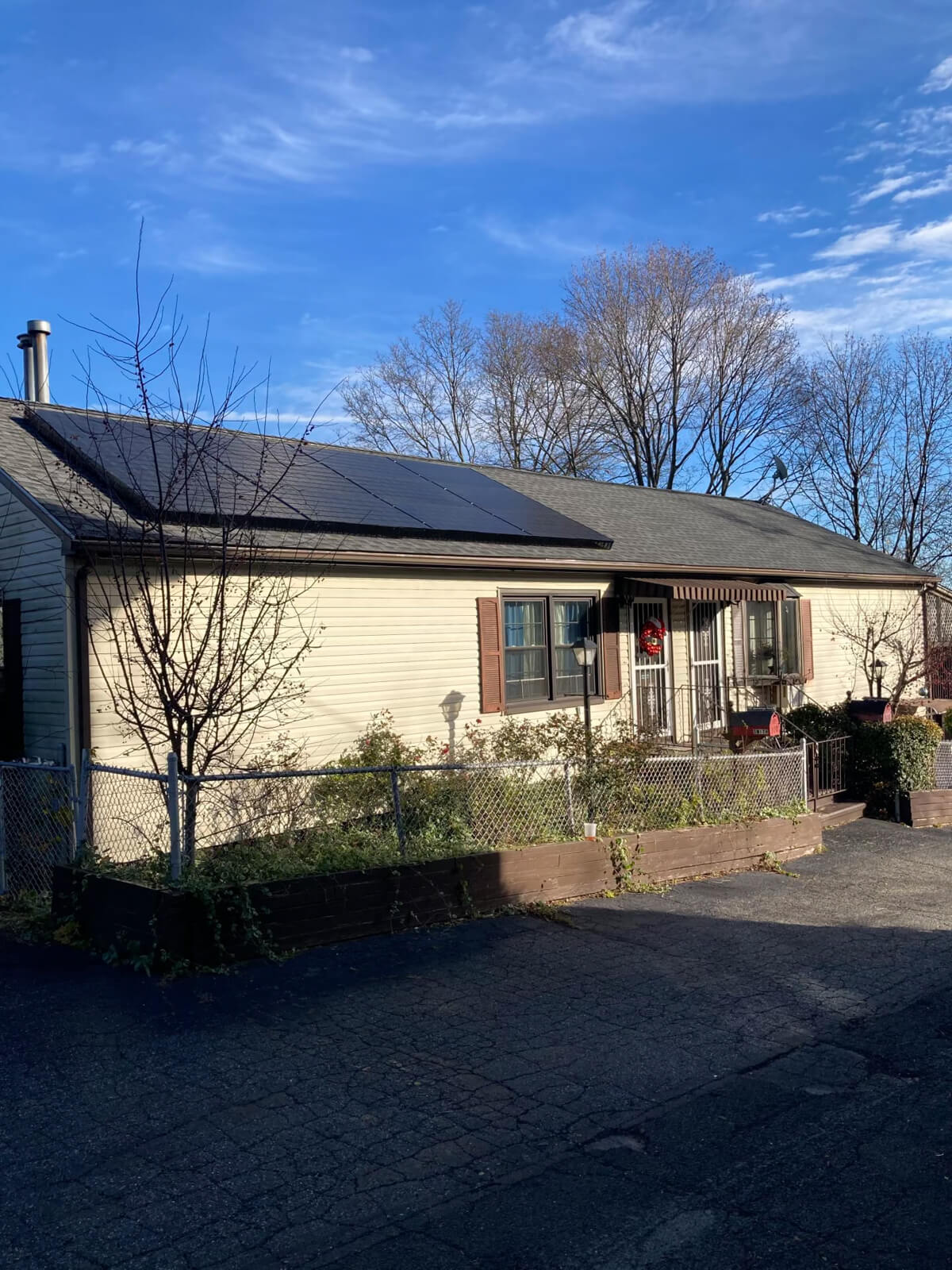 A home equipped with solar panels on the roof, helping reduce carbon emissions while providing reliable energy.