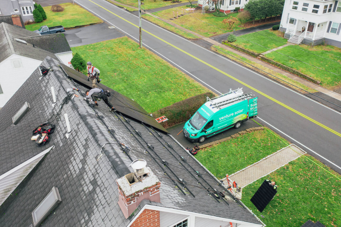 Venture Solar expert installers adding solar panels to a home’s roof, working to provide clean energy solutions.