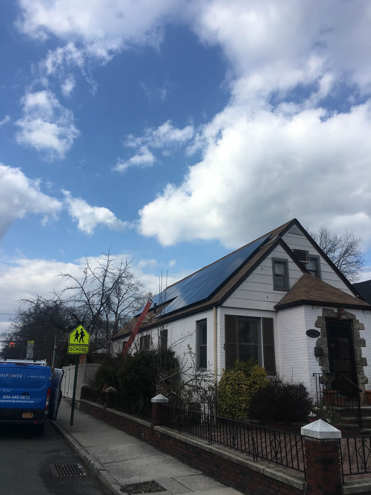 Solar panels on a residential on a white home installed by Venture Home experts. 