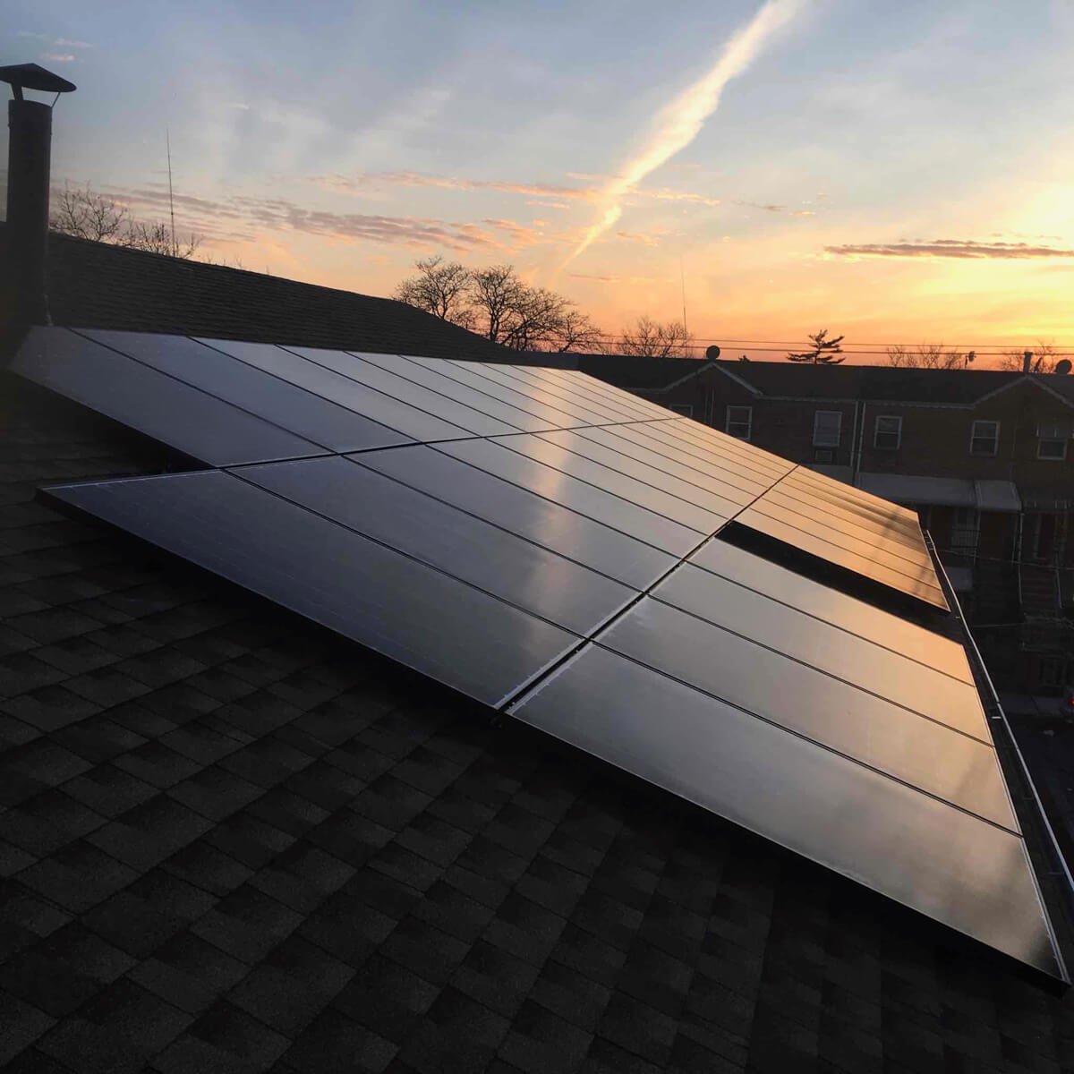 Solar panels shining as they reflect the stunning colors of the sunset.