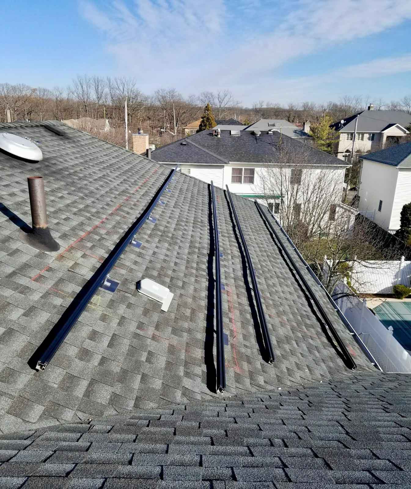 Equipment set up on a roof in preparation for solar panel installation.