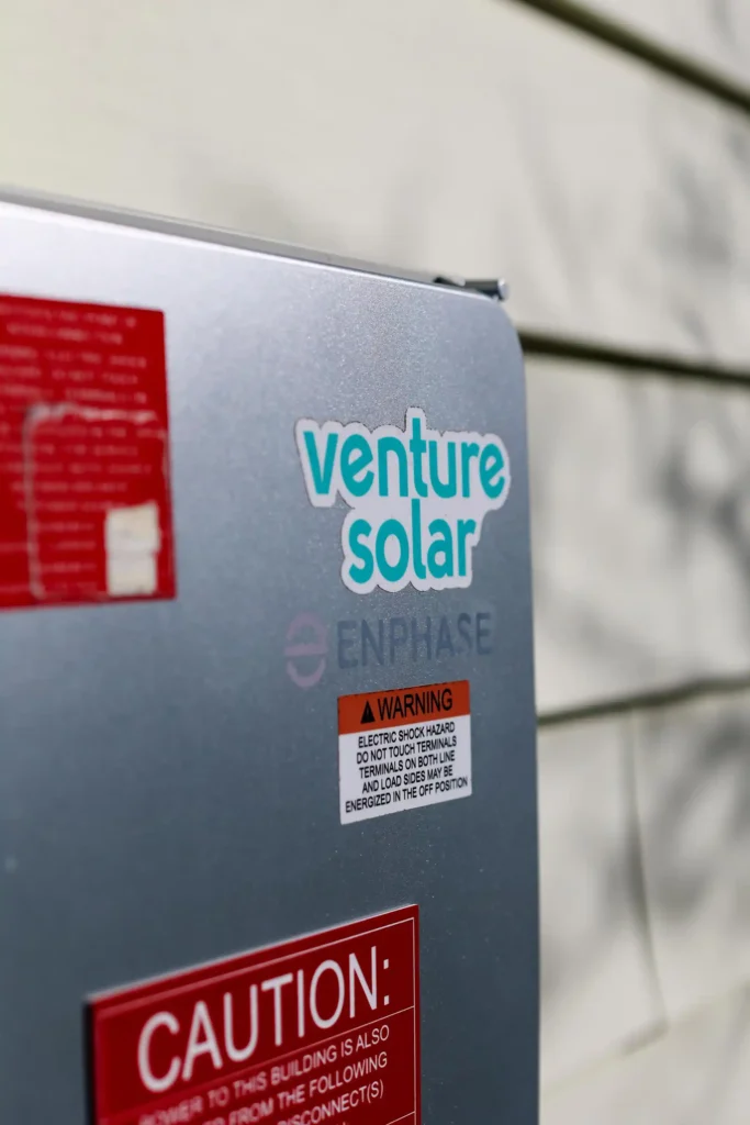 A Venture Home sticker on an Enphase battery, highlighting the partnership for clean energy solutions.